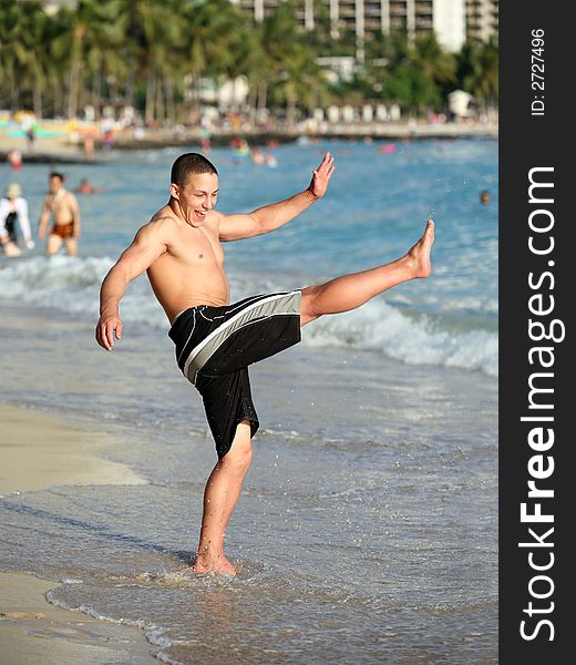 Happy teen boy having fun on the beach