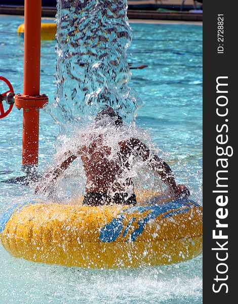 Little boy under waterfall at the pool. Little boy under waterfall at the pool