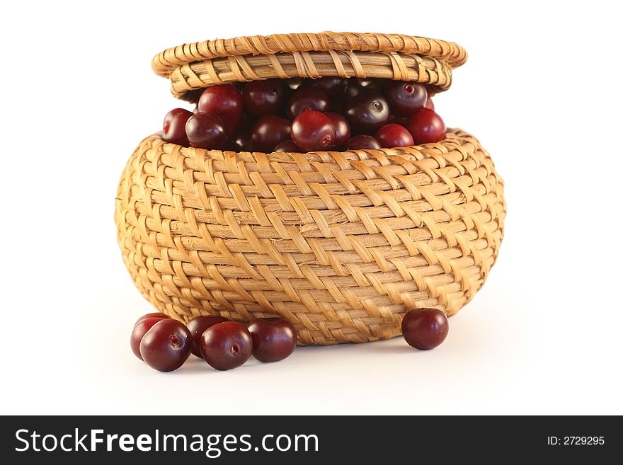 Cherry in a basket isolated on white