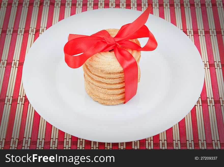 Christmas cookies in a plate with a bow on a napkin. Christmas cookies in a plate with a bow on a napkin.