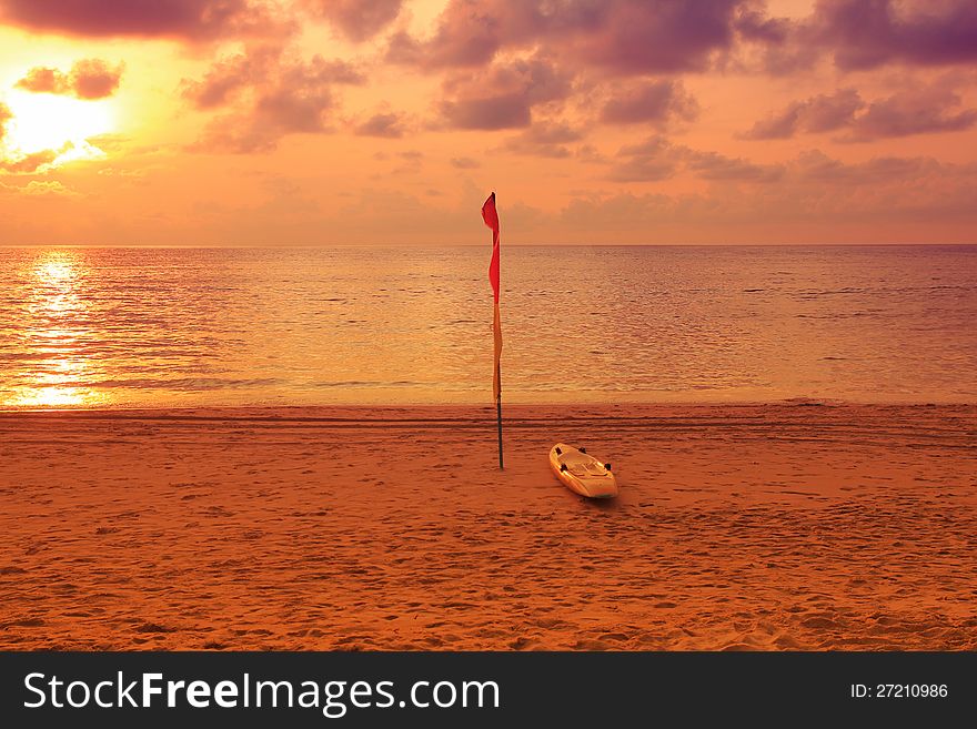 Kayak with flags on sunset beach. Kayak with flags on sunset beach