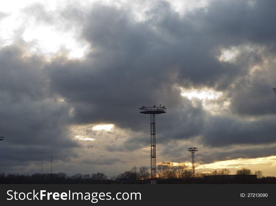 The storm sky over the airport in beams of the coming sun