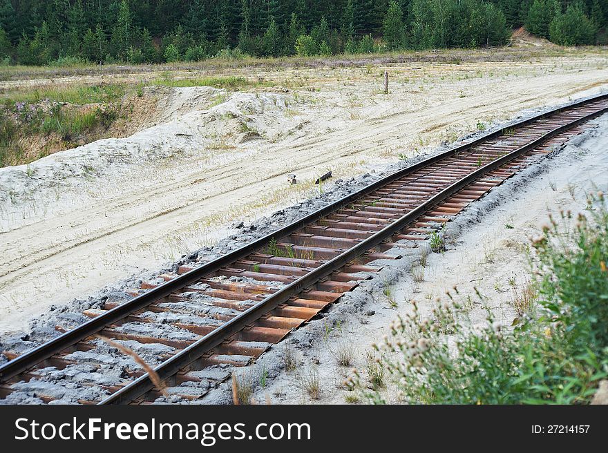 Old railroad tracks run through quarry