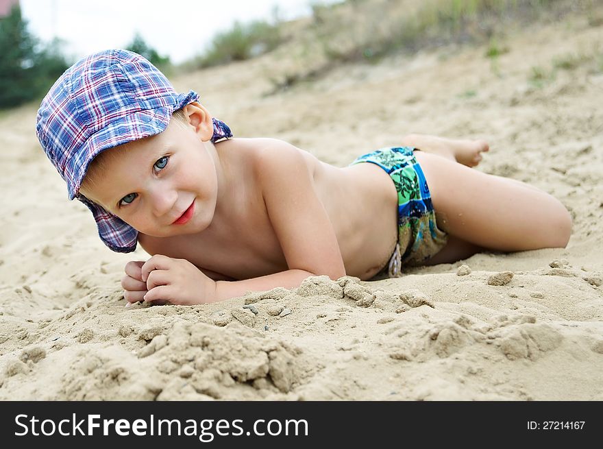 Little Boy Lying On The Sand