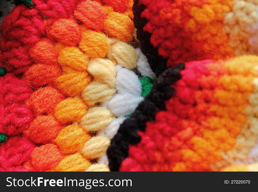 Bright, vivid & multicolored handwoven woolen table cloth closeup photo. The colors of the cloth include red, orange, yellow, green and pink. Bright, vivid & multicolored handwoven woolen table cloth closeup photo. The colors of the cloth include red, orange, yellow, green and pink.