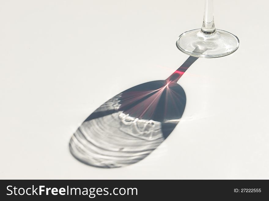 Red wine cup shadow in a table