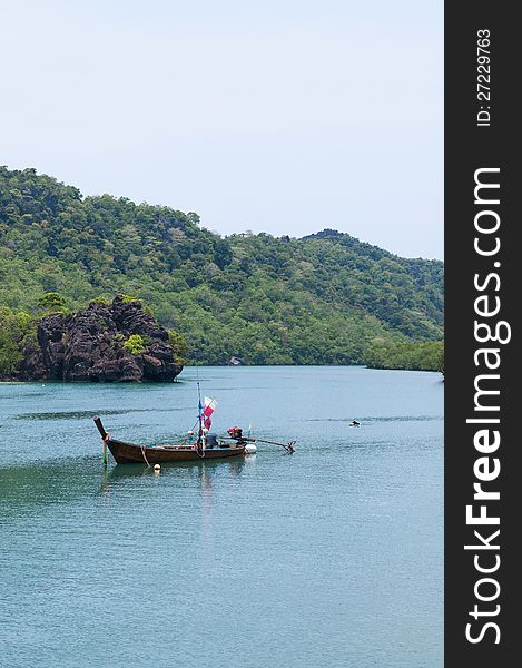 Floating boat on turqoiuse seascape.