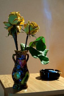 Vase With Yellow Dried Roses And Ashtray Royalty Free Stock Images