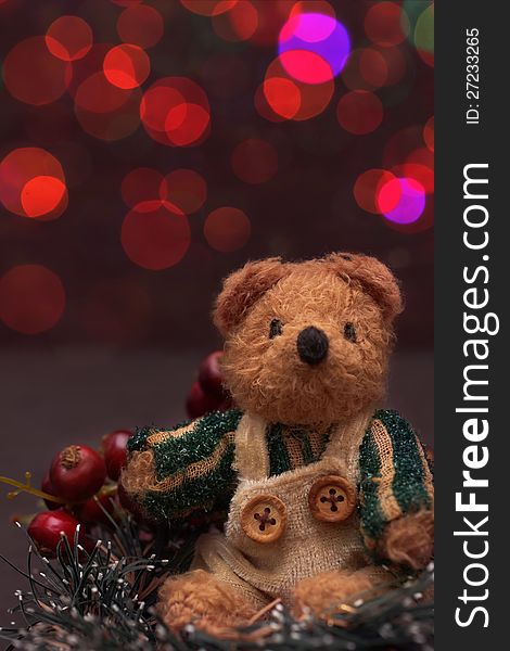 Christmas arrangement with a vintage teddy bear and red lights. Christmas arrangement with a vintage teddy bear and red lights