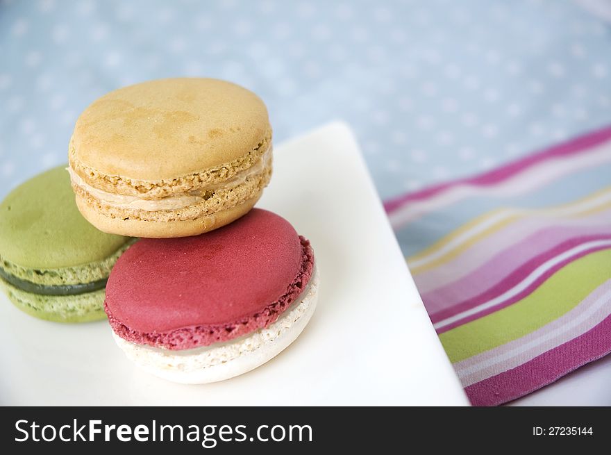 Sweet macarons on color line and polka dot background. Sweet macarons on color line and polka dot background