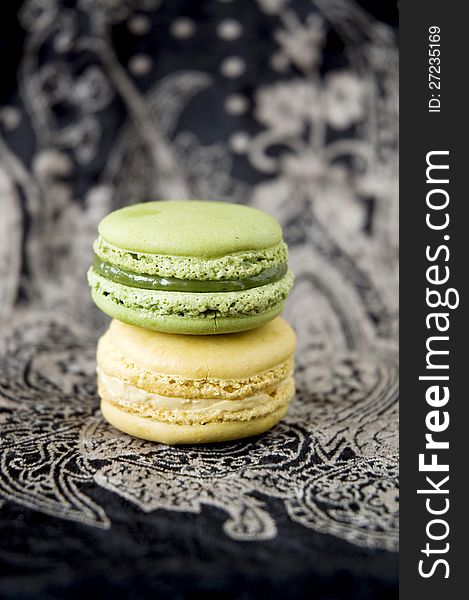 Two color macarons on black background