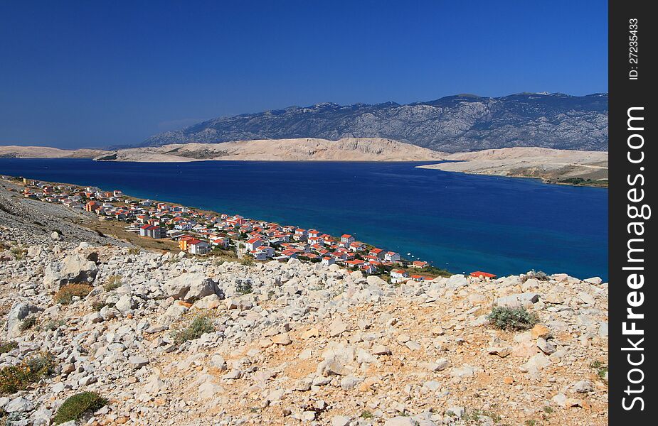 The pag village in Croatia (southeast Europe) during summer and the Velebit mountains in the background. The pag village in Croatia (southeast Europe) during summer and the Velebit mountains in the background.