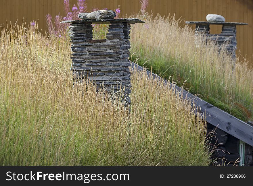 Two chimneys in grassy roofs