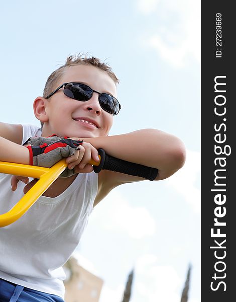 Boy on a bike outside in the summer day