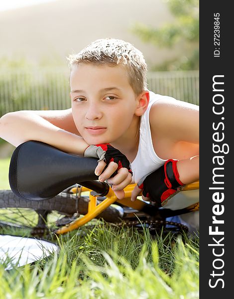 Sport boy with a bicycle outside