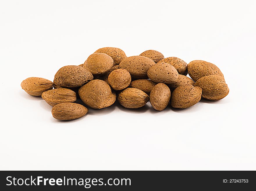 Almonds with rind on white background