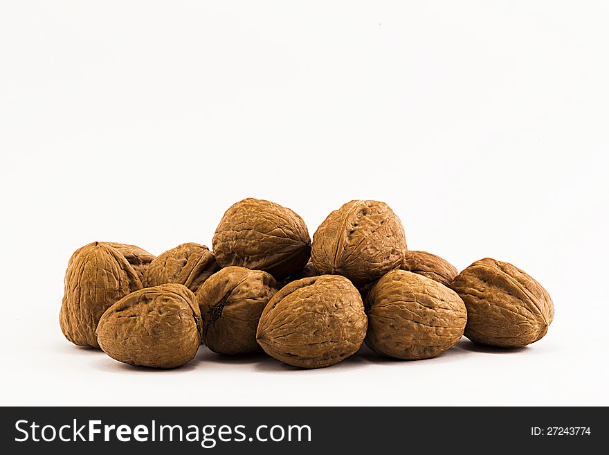 Nuts, ripe fruit of the walnut on white background.