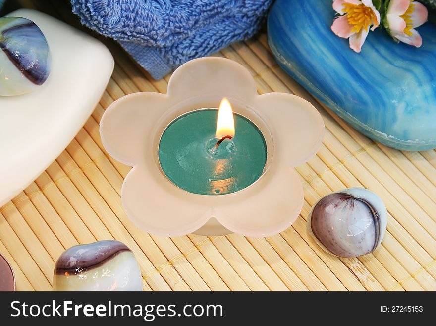 Candle, soaps, stones closeup picture.