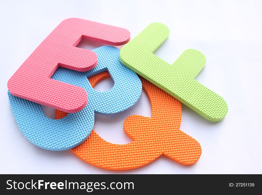 Pile of colorful letters on white background