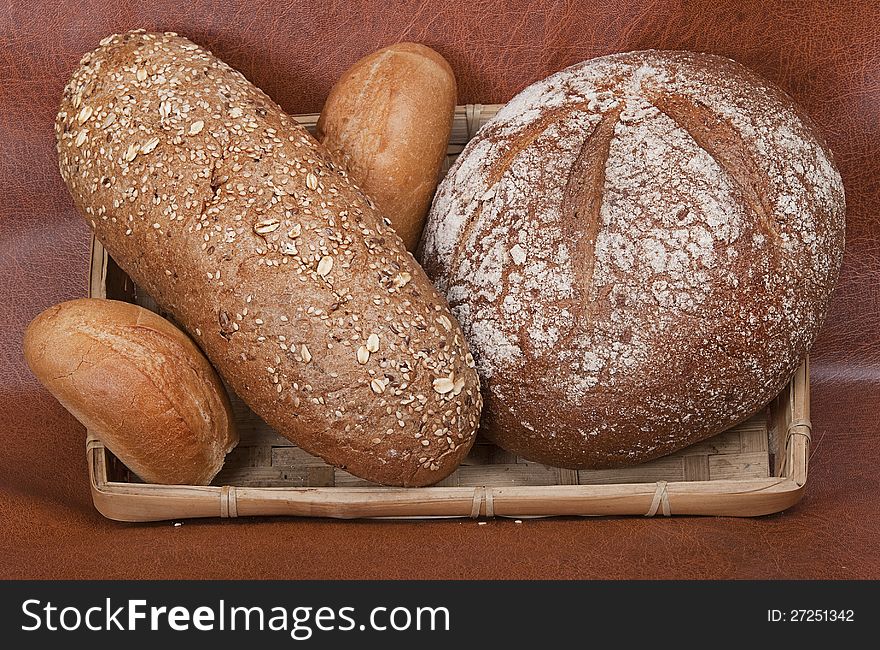 Group of different types of bread against a dark background