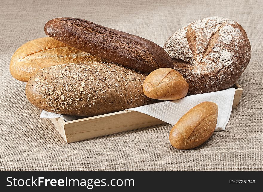 Group of different types of bread on a gray background