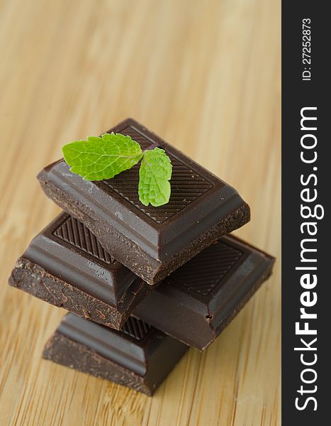 Slices of chocolate stacked with mint leaf. Slices of chocolate stacked with mint leaf