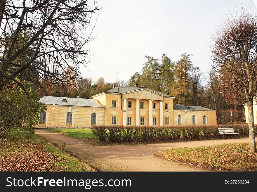 Eighteenth-century mansion in the background of trees in the rays of the evening sun. Eighteenth-century mansion in the background of trees in the rays of the evening sun