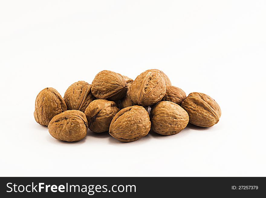 Nuts, ripe fruit of the walnut on white background.