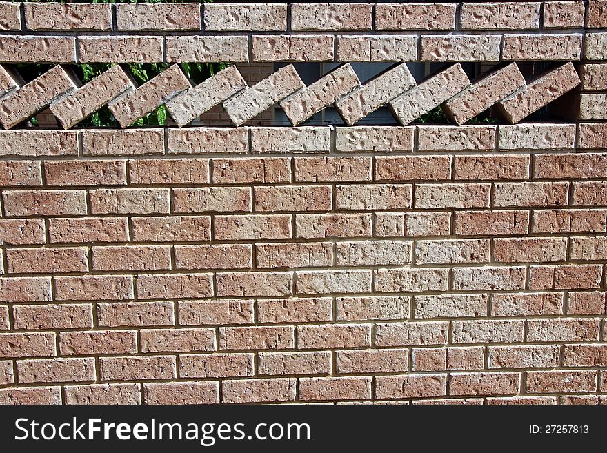 The row of textured bricks at an angle create a splendid ornamental patterned brick wall in this modern urban street scape. The row of textured bricks at an angle create a splendid ornamental patterned brick wall in this modern urban street scape.