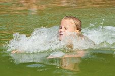 Little Girl Swimming In Lake Stock Photo