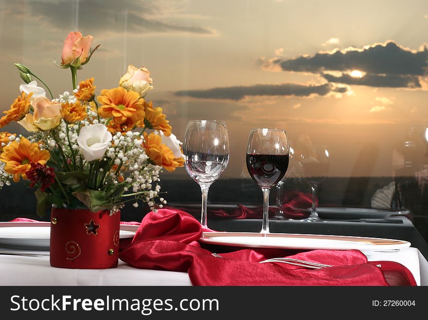 Beautiful flower arrangement and glasses decorating restaurant christmas table. Beautiful flower arrangement and glasses decorating restaurant christmas table