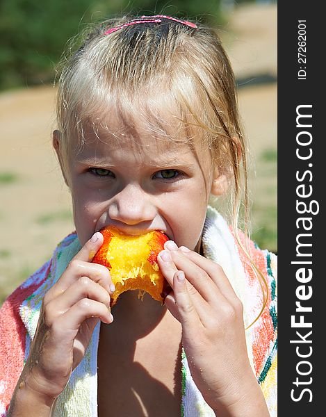 Little Girl Eating A Peach