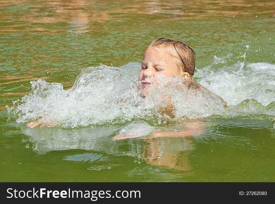 Little girl swimming in lake outdoors