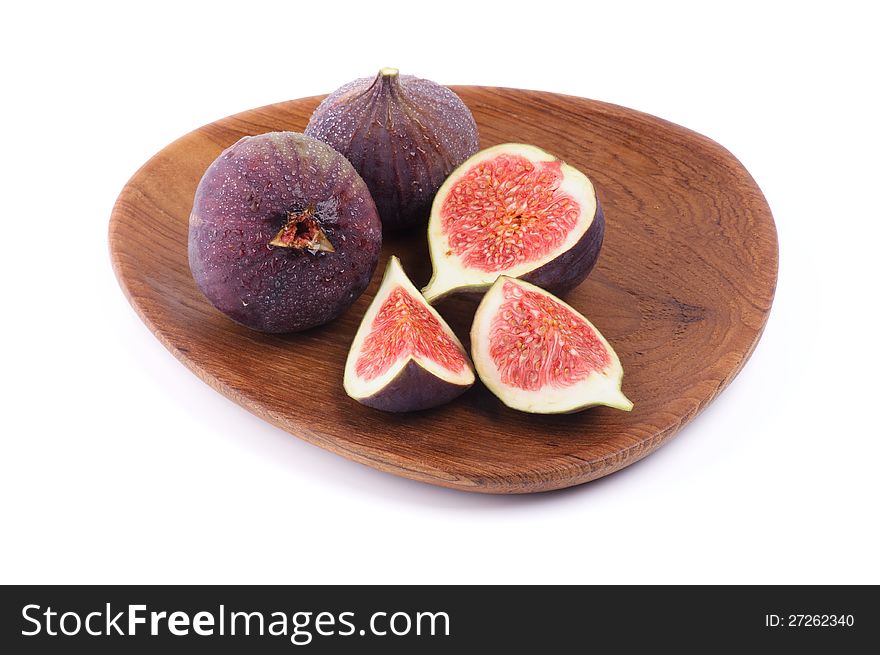 Perfect Figs Full Body and Slices on Wood Plate isolated on white background. Perfect Figs Full Body and Slices on Wood Plate isolated on white background