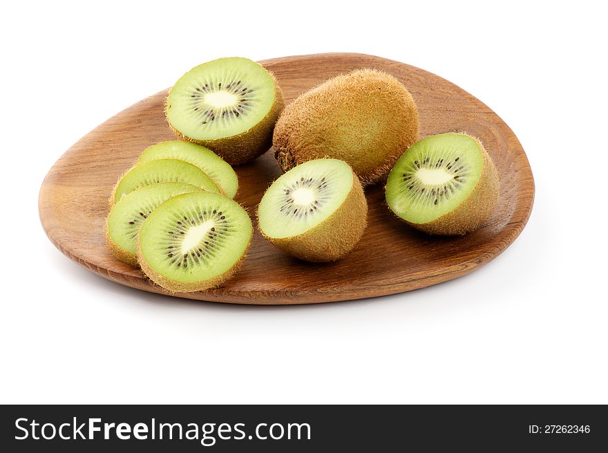 Perfect Kiwi Full Body and Slices on Wooden Plate isolated on white background. Perfect Kiwi Full Body and Slices on Wooden Plate isolated on white background