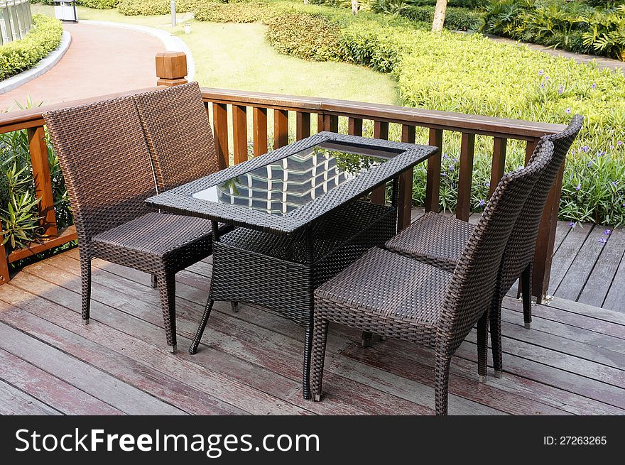 The photo of vine chair and table outdoor. The photo of vine chair and table outdoor.