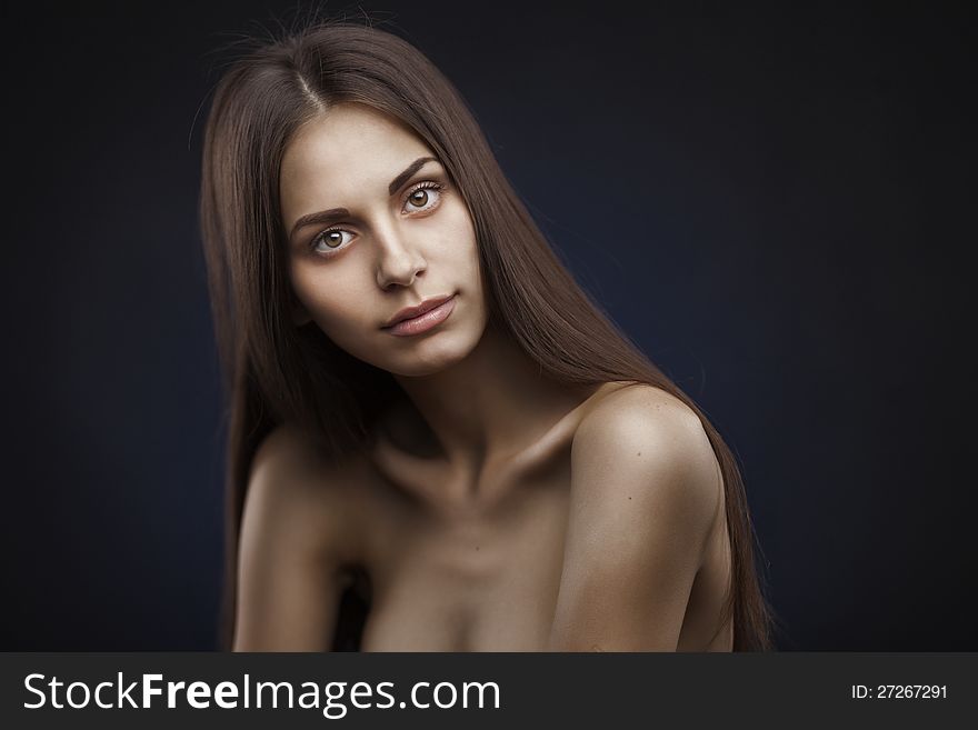 Beautiful woman with long hair on dark background