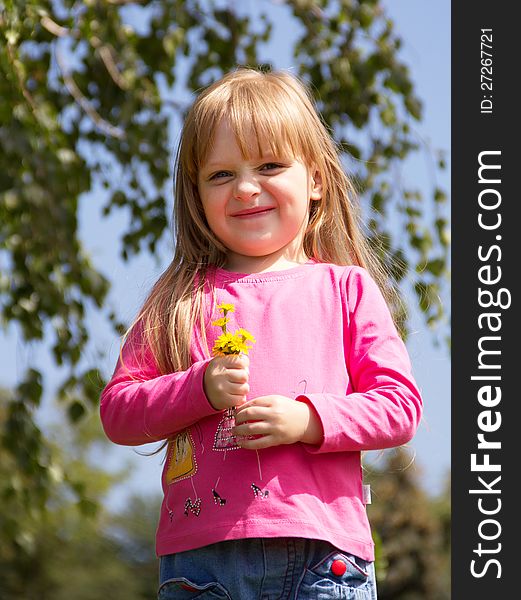 Funny little girl with flowers posing. Close up. Funny little girl with flowers posing. Close up