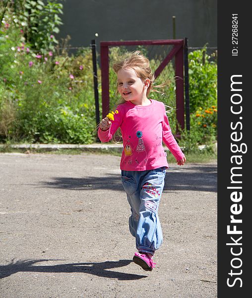 Happy little blond girl running on nature background. Happy little blond girl running on nature background