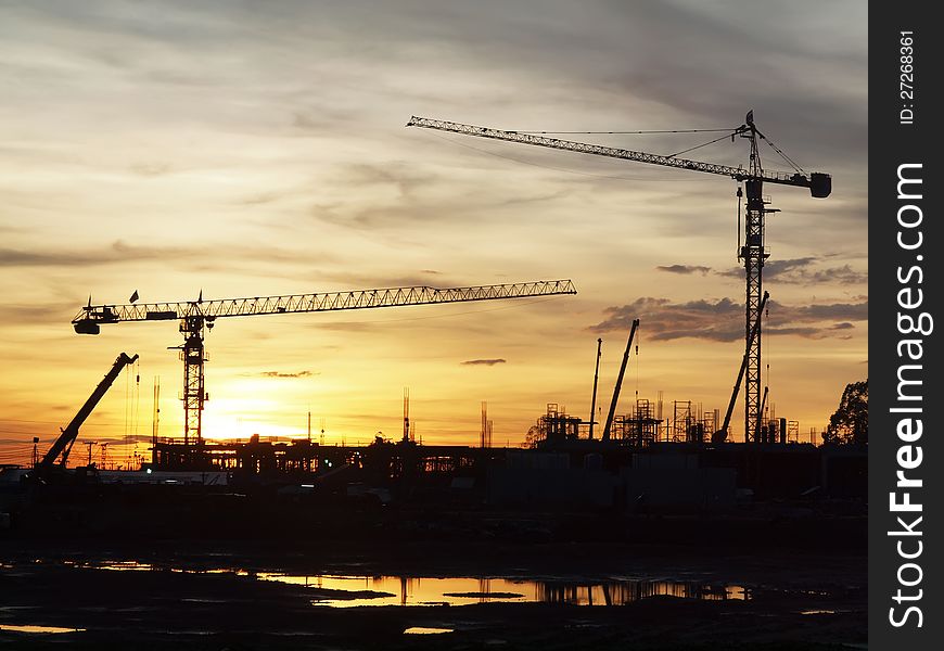 Silhouette industrial cranes in sunset. Silhouette industrial cranes in sunset