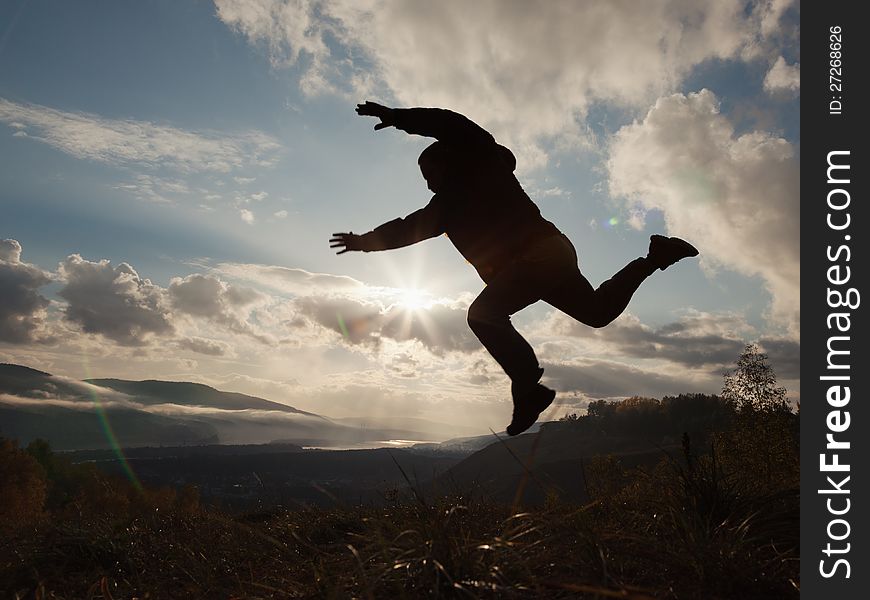 Happy man jumping at the sunset. Happy man jumping at the sunset