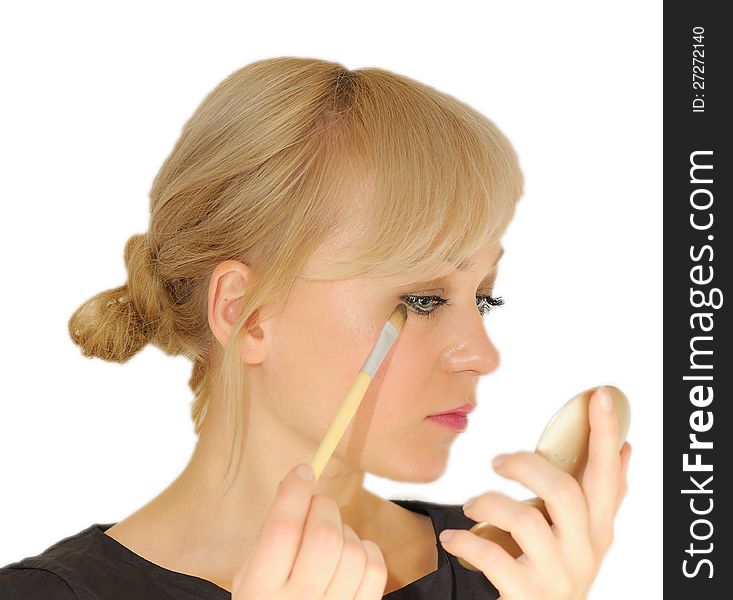 Young beautiful woman with a make-up brush
