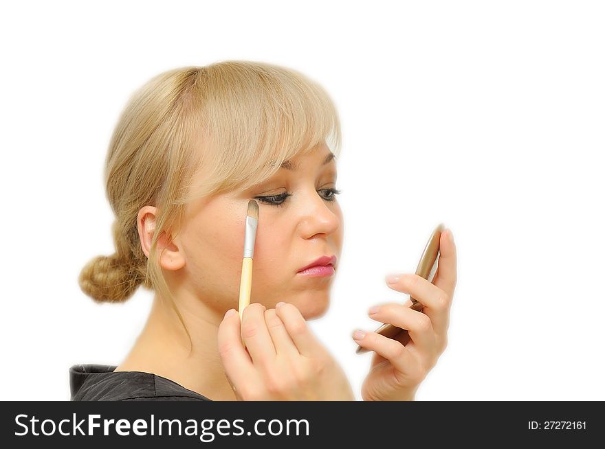 Young beautiful woman with a make-up brush, isolated on white.