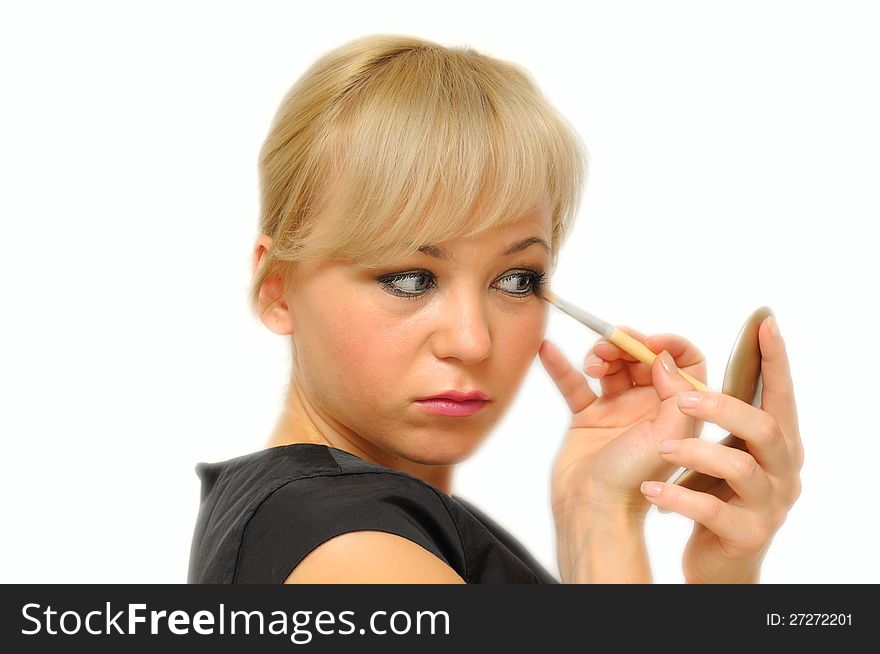 Young beautiful woman with a make-up brush, isolated on white.