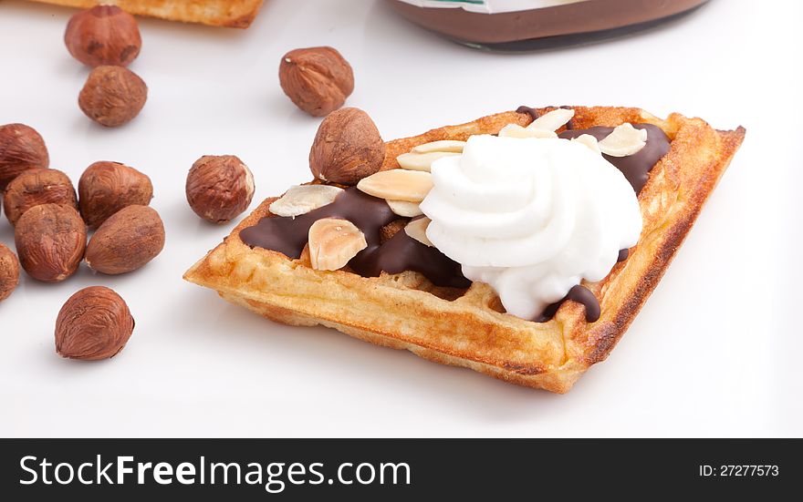 Close Up Of Chocolate Waffles Slice with vanilla cream and nuts