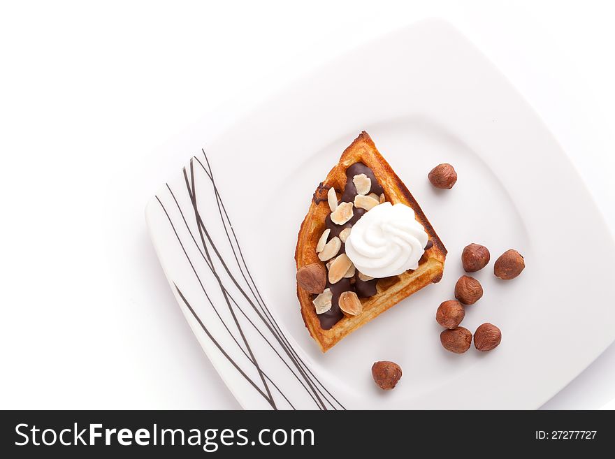 Close Up Of Chocolate waffles Slice with vanilla cream and nuts