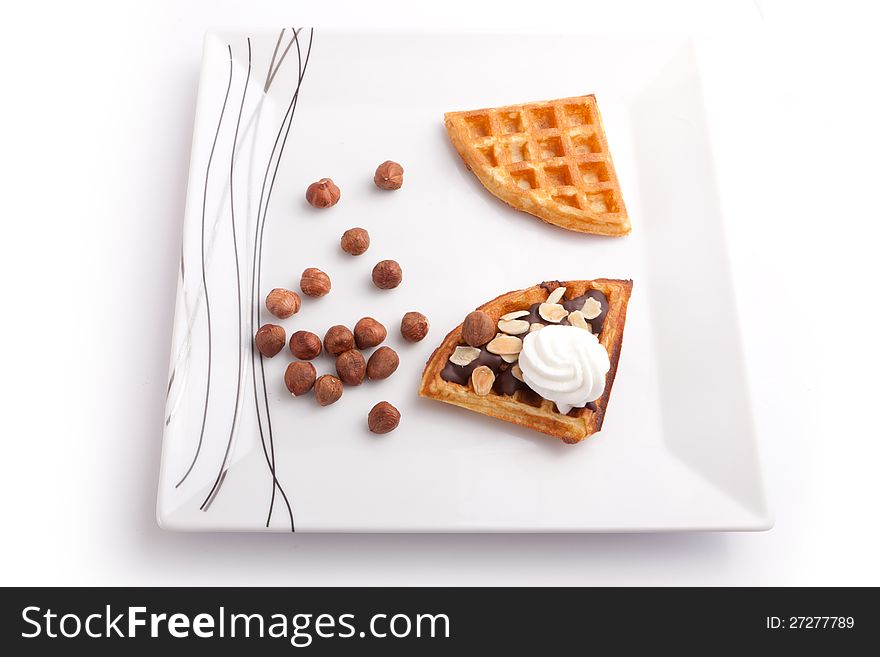 Close Up Of Chocolate Waffles Slice with vanilla cream and nuts