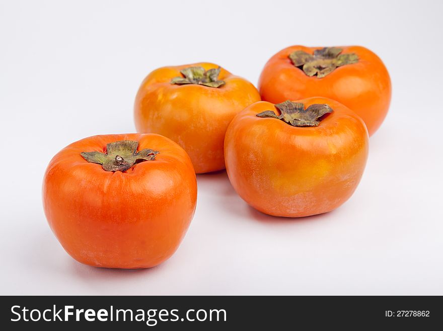 Persimmons  with white background top view. Persimmons  with white background top view