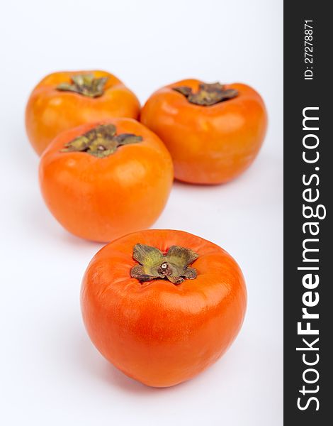 Persimmons  with white background top view. Persimmons  with white background top view