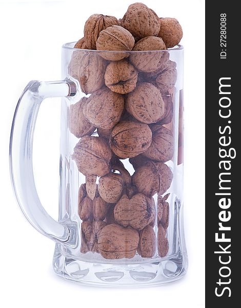 Transparent mug filled with walnuts. Transparent mug filled with walnuts